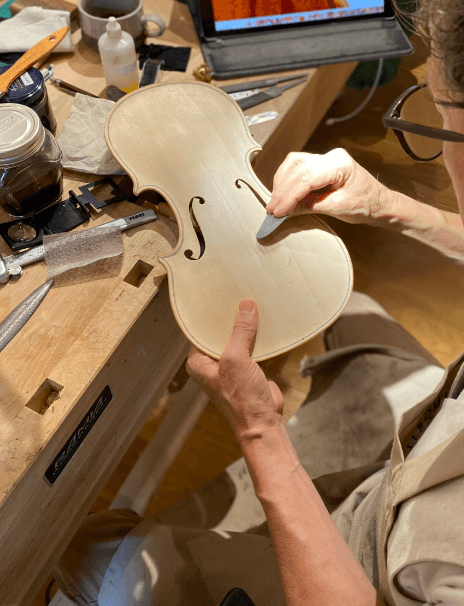 A luthier making a good violin at his workshop